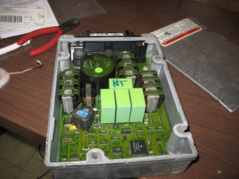 1995 Ford C-350 (Centurion Conversions) - Internal components of an electronic control unit, with tools present for repair or modification.