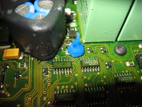 1995 Ford C-350 (Centurion Conversions) - A close-up view of a green circuit board shows various electronic components and a blob of blue thermal paste.
