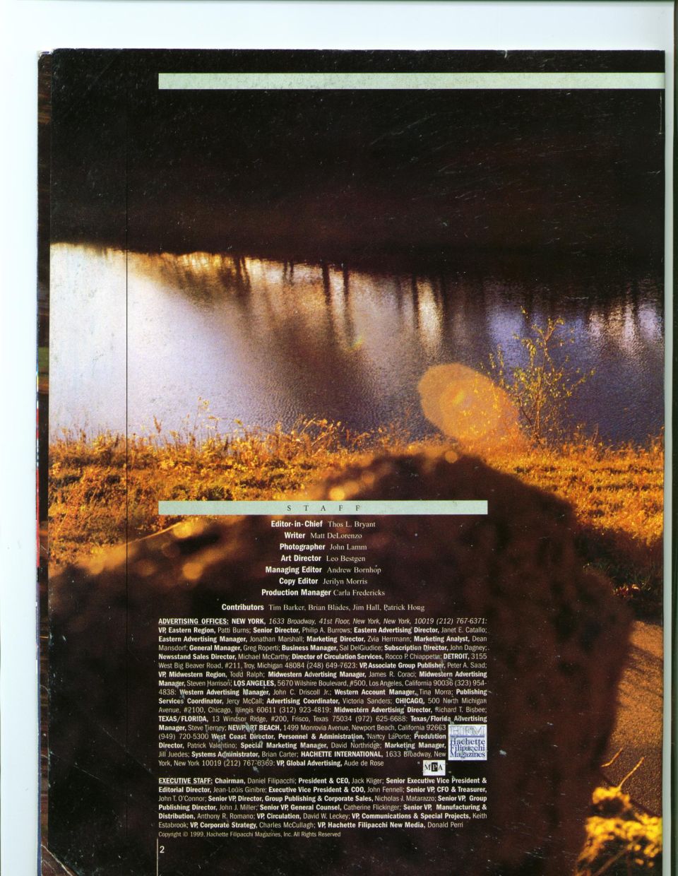 Magazine staff and credits page with a dark riverside photo