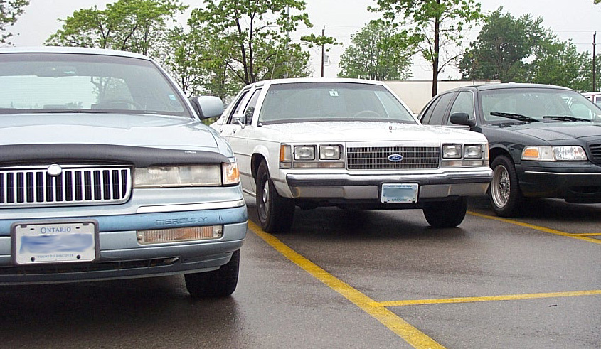 White 2001 Ford Crown Victoria parked in a lot, front view