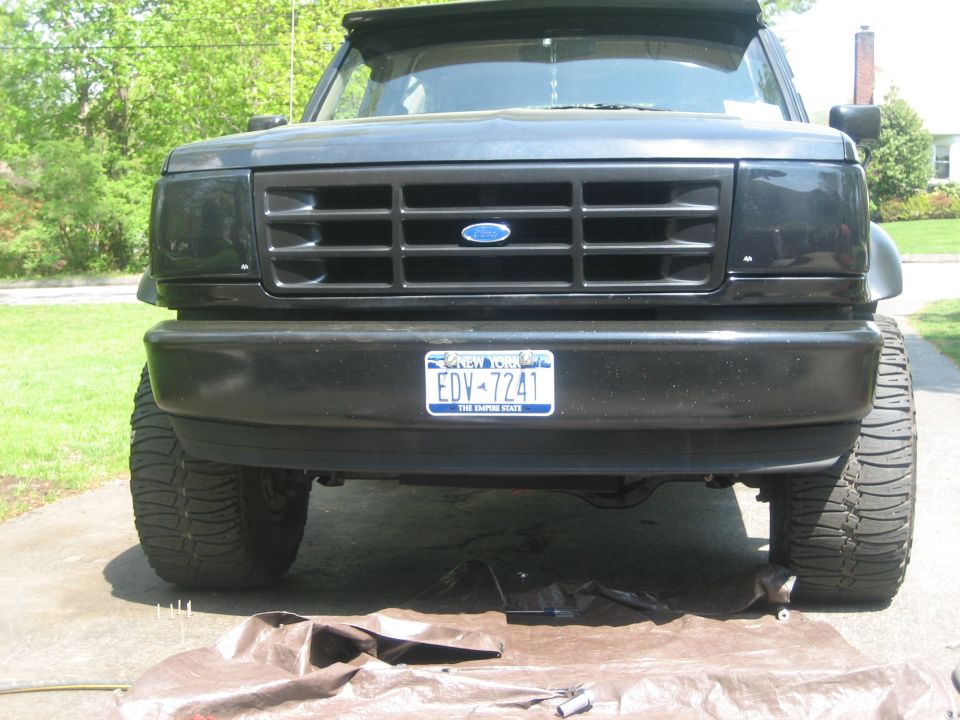 Front view of a black Ford Bronco with a grille that looks like it's from the early 90s