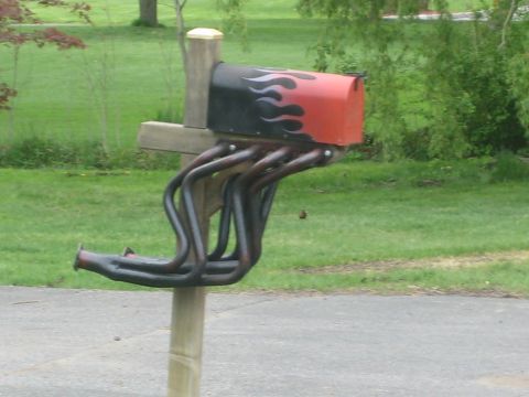 1995 Ford Bronco - A mailbox is modified to look like a car part, with exhaust headers serving as a decorative element.
