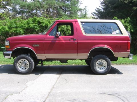 1995 Ford Bronco - This 1995 Ford Bronco is shown from the side, a two-tone paint scheme and lifted suspension.