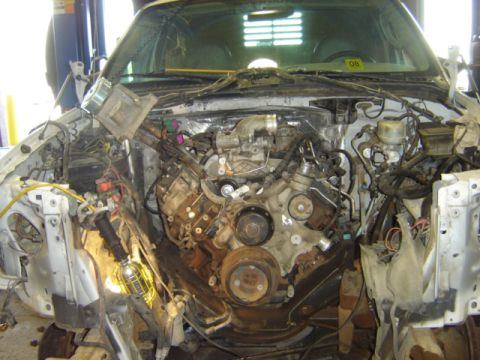 1992 Ford Bronco - Engine bay of a truck with the hood removed, showing the engine and various components.