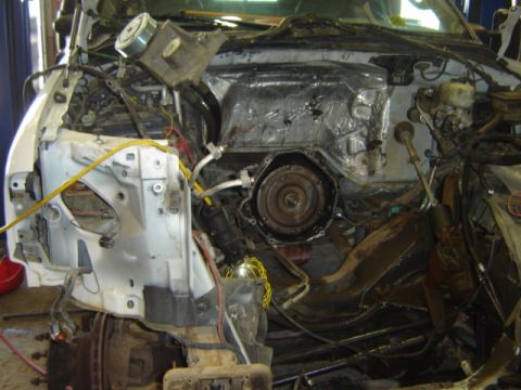 1992 Ford Bronco - The engine bay of a vehicle is shown with parts removed for repair or maintenance.