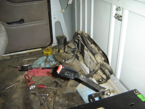 1992 Ford Bronco - Tools and wiring are scattered inside the vehicle's interior.