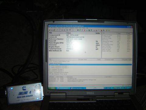 1992 Ford Bronco - Photograph of a laptop showing diesel engine diagnostic software next to a Cummins Inline 4 data link adapter.
