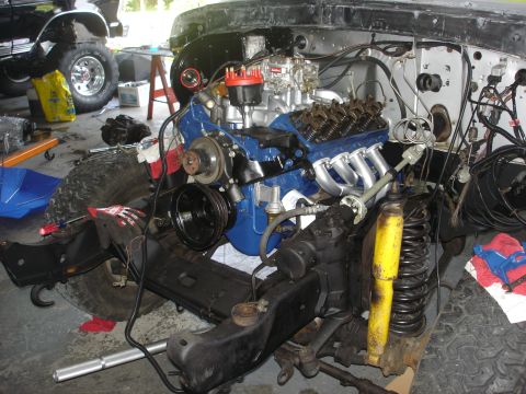 1979 Ford Bronco - Disassembled engine and chassis components are laid out, suggesting a vehicle under repair or restoration.