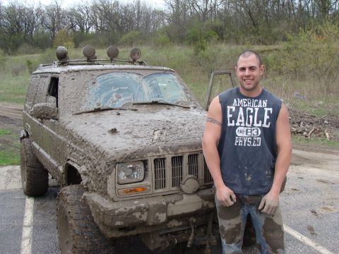1992 Ford Bronco - A man and his heavily mud-splattered Jeep pose for a photo after an off-road adventure.
