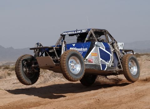2008 Ford Bronco - This off-road buggy is mid-air during a race, displaying sponsor decals.