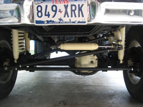 1979 Ford Bronco - Undercarriage view of a vehicle, suspension and steering parts, and a Texas license plate.