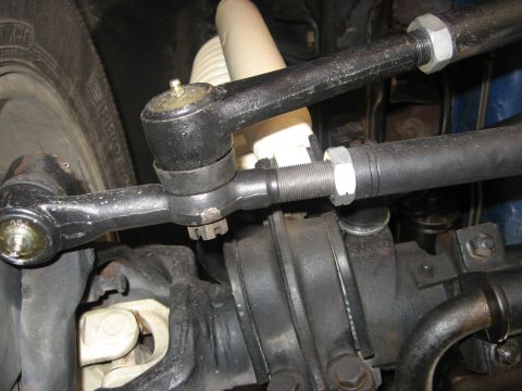 1979 Ford Bronco - Close-up of the steering linkage and shock absorber assembly.