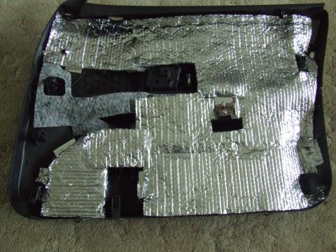2003 Ford Crown Victoria - Car door panel interior showing sound deadening material application.