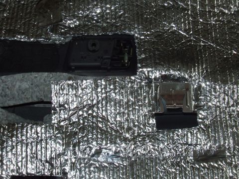 2003 Ford Crown Victoria - Sound deadening material is applied to the interior of a car door panel.