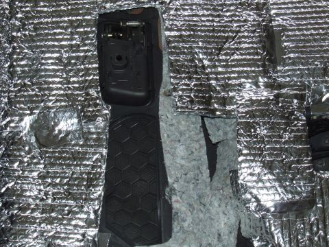 2003 Ford Crown Victoria - Car interior insulation and trim are visible, with a black textured pedal area.