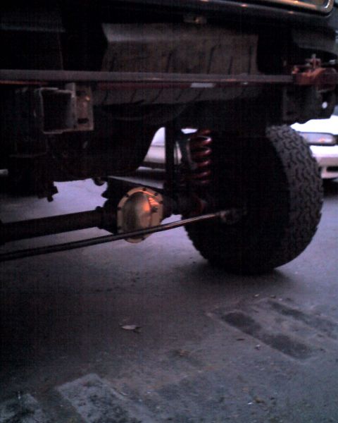 1996 Ford F-150 - The rear suspension and axle of a 1996 Ford F-150 are visible, with another vehicle in the background.