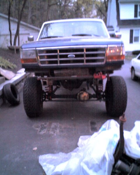 1996 Ford F-150 - This lifted 1996 Ford F-150 truck is shown from the front, highlighting its modified suspension system.