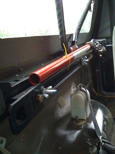 1993 Ford Bronco - Hi-Lift jack secured with a yellow zip tie and wing nuts to interior mounting brackets.