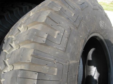1986 Ford Bronco - A detailed view of a heavy-duty tire, showing its deep, blocky tread designed for terrain.