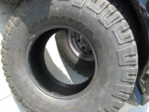 1986 Ford Bronco - Close-up of Goodyear Wrangler MT/R tires, suggesting off-road capability.