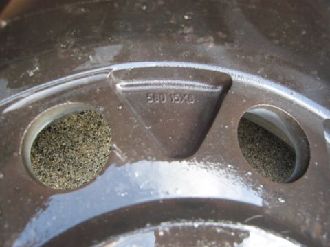 1986 Ford Bronco - Close-up of a wheel showing the text '500 15X6' cast into the metal.