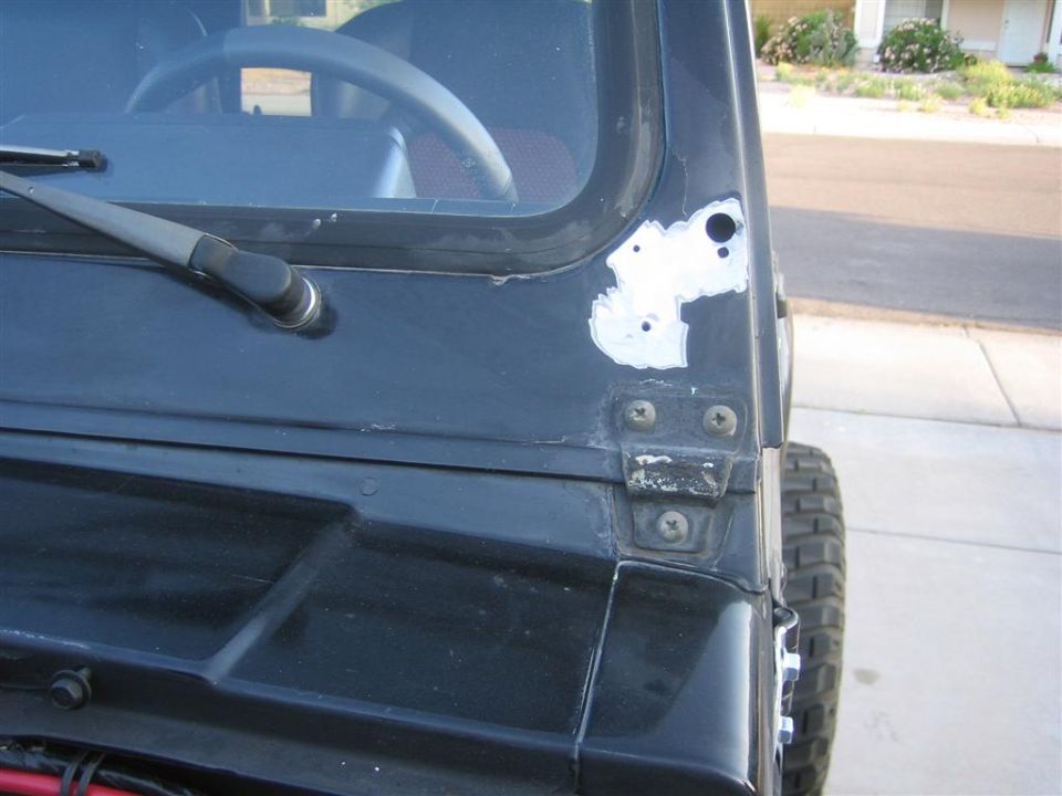 Black 4x4 door with paint ground to bare metal around mirror mount and hinge