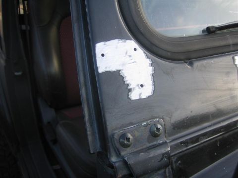 1987 Suzuki Samurai - Close-up of a vehicle's door jamb showing body filler and screw holes, indicating repair work.