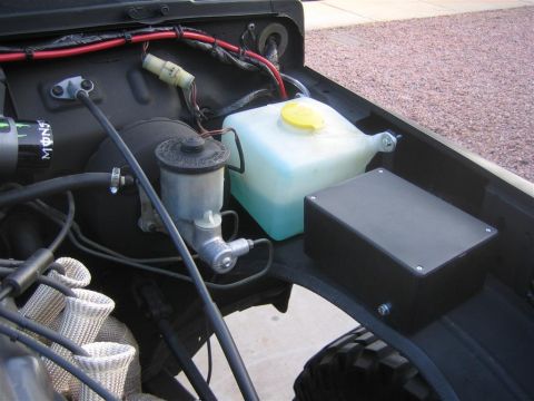 1987 Suzuki Samurai - Close-up of engine bay components including master cylinder and fluid reservoir.