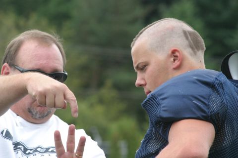 1993 Ford Bronco - A coach gestures emphatically while speaking to a young football player.