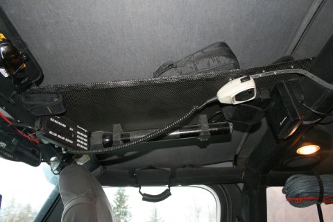 2003 Jeep TJ - Interior view of a vehicle's overhead console, equipped with a CB radio, flashlight, and microphone.