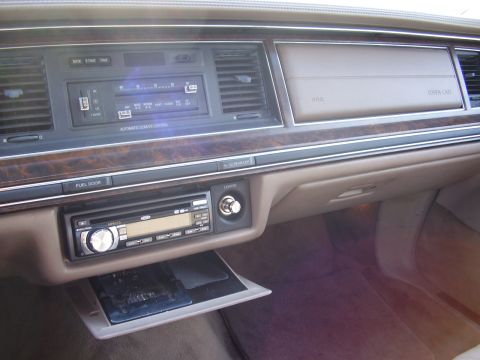 1996 Ford F-150 - The interior dashboard features wood trim, climate controls, and an aftermarket stereo system.