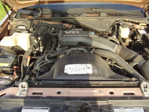 1996 Ford F-150 - Engine bay view showing V8 OVERHEAD CAM engine components and radiator. No specific year identified.