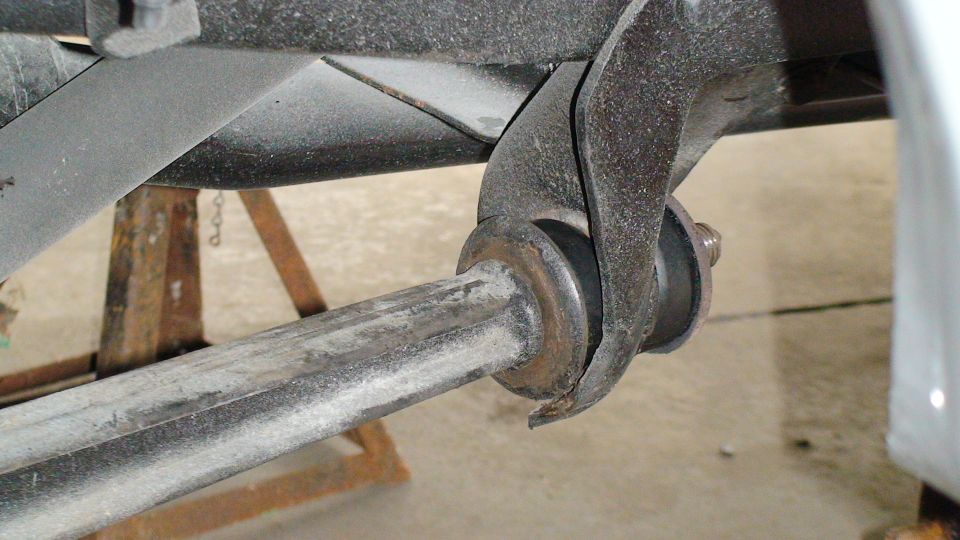 Close-up of a vehicle's rear suspension linkage and bushing