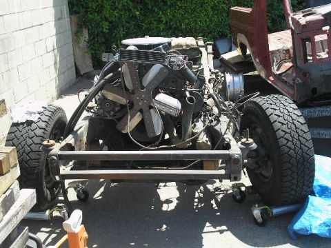 1986 Ford Bronco - The chassis and engine of a 1986 Ford Bronco are shown during a tear-down process.