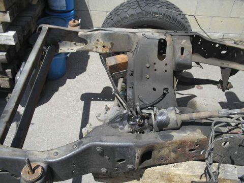 1986 Ford Bronco - Close-up view of a vehicle's frame and suspension components, showing signs of wear and tear.