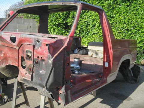 1986 Ford Bronco - This stripped-down 1980s Ford Bronco body is undergoing restoration, revealing its internal structure and rear section.