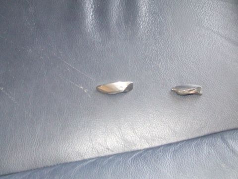 1990 Ford Bronco - Two metal fragments are visible on the blue leather surface.
