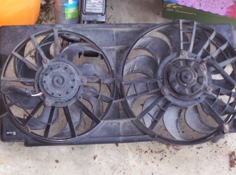 1995 Ford Probe - Dual radiator fan assembly with black plastic shroud and visible wiring.