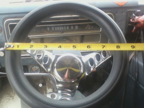 1992 Ford F-350 - Interior view of a vehicle's steering wheel and dashboard, with a tape measure indicating dimensions.