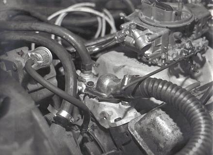 2000 Ford Crown Victoria - Engine bay detail showing carburetor, fuel filter, and associated plumbing.