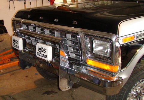 1979 Ford Bronco - Front view of a 1979 Ford Bronco, a chrome grille and bumper with auxiliary lights.