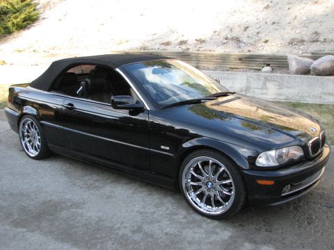 2002 BMW 3 Series - Black 2002 BMW 3 Series convertible parked outdoors with the top down.