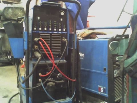 1992 Ford Bronco - A blue welding machine with various cables and hoses is shown in a workshop setting.