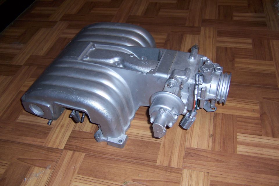 Silver aluminum intake manifold with throttle body and sensors