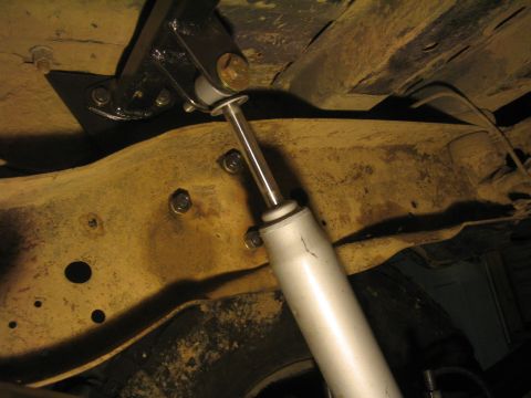 1979 Ford Bronco - Underside view of a vehicle's suspension system with a shock absorber and mounting hardware.