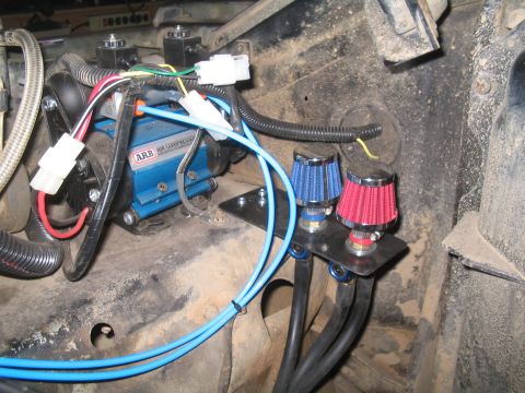 1979 Ford Bronco - Close-up of an ARB air compressor and dual air filters, likely part of an off-road modification.