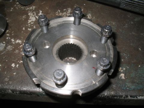 1979 Ford Bronco - Close-up of a metal hub assembly with six bolts and a splined center bore.