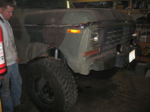 1979 Ford Bronco - Front view of a 1979 Ford Bronco with a camouflage paint scheme and aftermarket bumper.