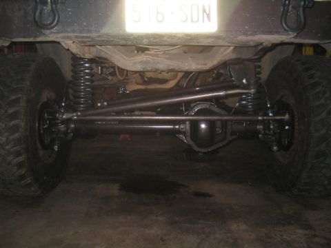 1979 Ford Bronco - Close-up view of a vehicle's rear axle and suspension components, with a license plate visible.