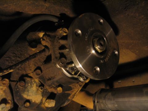 1979 Ford Bronco - Close-up view of a differential with a newly installed flange adapter, indicating a modification or repair.